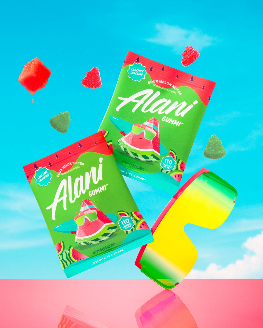 Sour Melon Slice pouches and gummies displayed next to sunglasses and juicy watermelon cubes.